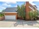 Spacious two-car garage attached to the brick home, surrounded by mature trees for added privacy at 1402 Bromley Dr, Snellville, GA 30078