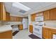 A functional kitchen featuring ample cabinetry, a gas range, and essential appliances for easy cooking at 1402 Bromley Dr, Snellville, GA 30078