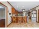 Well-lit kitchen with warm wood cabinetry, bar seating, and tile flooring at 1402 Bromley Dr, Snellville, GA 30078