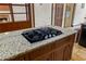 Gas cooktop on island with granite countertop in updated, eat-in kitchen at 1402 Bromley Dr, Snellville, GA 30078