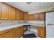 Kitchen featuring abundant wood cabinetry, countertop space, and sink with dual basins at 1402 Bromley Dr, Snellville, GA 30078