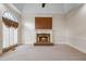 Comfortable living room with fireplace, tray ceiling, and natural light at 1402 Bromley Dr, Snellville, GA 30078