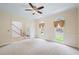 Bright living room with neutral carpet, large windows, and an open entrance to the foyer at 1402 Bromley Dr, Snellville, GA 30078