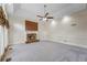 Spacious living room with a brick fireplace, plush carpet, and decorative molding at 1402 Bromley Dr, Snellville, GA 30078