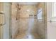 Luxurious shower featuring glass doors, dual shower heads, and tiled walls with inset niches at 1402 Bromley Dr, Snellville, GA 30078