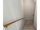 Carpeted stairwell featuring wood railing and neutral wall paint at 1402 Bromley Dr, Snellville, GA 30078