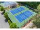 Aerial view of community tennis courts, professionally lit and maintained with covered seating for spectators at 1402 Bromley Dr, Snellville, GA 30078