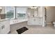 Well-lit bathroom with a soaking tub, white cabinets, and granite countertops at 1584 Heartland Path, Hoschton, GA 30548