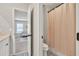 Open bathroom revealing patterned floors, bath with curtain, and view to the bedroom at 1584 Heartland Path, Hoschton, GA 30548