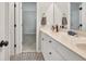 Bathroom featuring double vanity, matte black hardware and patterned tile flooring at 1584 Heartland Path, Hoschton, GA 30548
