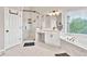 Clean bathroom featuring a glass enclosed shower and a soaking tub at 1584 Heartland Path, Hoschton, GA 30548