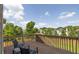 Relaxing on the wooden deck with patio chairs and views of surrounding trees and neighborhood at 1584 Heartland Path, Hoschton, GA 30548