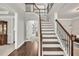 Spacious foyer with hardwood floors and a staircase leading to the second floor at 1584 Heartland Path, Hoschton, GA 30548