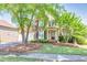 Charming two-story brick home featuring a well-manicured lawn and a two-car garage at 1584 Heartland Path, Hoschton, GA 30548