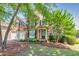 Charming two-story brick home featuring a well-manicured lawn and a two-car garage at 1584 Heartland Path, Hoschton, GA 30548