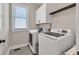 Efficient laundry room featuring modern appliances and storage at 1584 Heartland Path, Hoschton, GA 30548