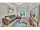 Cozy living room with a comfortable sofa, stylish rug, and natural light from the window at 1584 Heartland Path, Hoschton, GA 30548