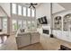 Open concept living room with large windows, a fireplace, and plenty of seating at 1584 Heartland Path, Hoschton, GA 30548