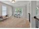 Loft with a sitting area, bright windows, and carpeted floors at 1584 Heartland Path, Hoschton, GA 30548