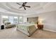 Comfortable main bedroom with a ceiling fan and sunny sitting area at 1584 Heartland Path, Hoschton, GA 30548