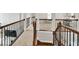 Staircase and landing featuring beautiful railing details and carpeted steps at 1584 Heartland Path, Hoschton, GA 30548