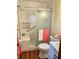 Modern bathroom with a glass-enclosed shower, tiled walls, and wood-look floor at 162 Apple Valley Dr, Woodstock, GA 30188