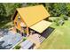 An aerial view highlighting the roof, hot tub, covered patio, and surrounding landscape at 6980 Lamplighter Ln, Winston, GA 30187