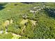 Aerial view of the property with treed lot and meadow, nestled in a leafy community at 6980 Lamplighter Ln, Winston, GA 30187