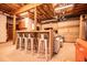 This basement features an entertainment area with a kitchenette and bar seating at 6980 Lamplighter Ln, Winston, GA 30187