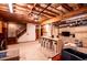 This basement features an entertainment area with an kitchenette, bar seating, and stairs at 6980 Lamplighter Ln, Winston, GA 30187