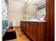Bathroom with wooden cabinets, a white countertop, a window and rustic wooden floors at 6980 Lamplighter Ln, Winston, GA 30187
