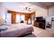 This bedroom features wood paneling, a ceiling fan, and neutral colors at 6980 Lamplighter Ln, Winston, GA 30187
