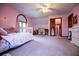 Bright bedroom with plush carpeting, a ceiling fan, and a large window for ample natural light at 6980 Lamplighter Ln, Winston, GA 30187
