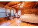 Bedroom featuring wood floors, a ceiling fan, natural light, and a desk area at 6980 Lamplighter Ln, Winston, GA 30187