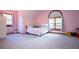 Bright bedroom with plush carpet, a big arched window, and comfortable furnishings, perfect for a  at 6980 Lamplighter Ln, Winston, GA 30187