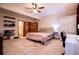 This bedroom features wood paneling, a ceiling fan, and neutral colors at 6980 Lamplighter Ln, Winston, GA 30187