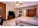 This bedroom features wood paneling, a ceiling fan, and attached bathroom at 6980 Lamplighter Ln, Winston, GA 30187