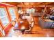 Bright dining area with large windows, wood beam ceiling, views of the living room, and decorative dining table at 6980 Lamplighter Ln, Winston, GA 30187