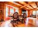 Bright dining area with large windows, wood beam ceiling, view into living room, and decorative chandelier at 6980 Lamplighter Ln, Winston, GA 30187