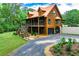 Gorgeous log cabin home with garage, spacious deck, and vibrant landscaping at 6980 Lamplighter Ln, Winston, GA 30187