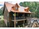 Charming log cabin home featuring a metal roof, large deck, and wooded surroundings at 6980 Lamplighter Ln, Winston, GA 30187