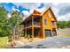 Beautiful log home with a large deck, garage, and well-manicured landscaping at 6980 Lamplighter Ln, Winston, GA 30187