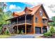 Stunning log cabin-style home with a metal roof, a large deck, and a two-car garage at 6980 Lamplighter Ln, Winston, GA 30187