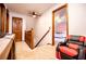 Upstairs hallway featuring stairs, carpet flooring, and a doorway leading to a bedroom at 6980 Lamplighter Ln, Winston, GA 30187