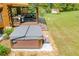 A secluded hot tub offering a serene outdoor experience with a lush yard and trees at 6980 Lamplighter Ln, Winston, GA 30187
