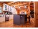 Open kitchen featuring a wooden island, modern pendant lighting, and views to another room at 6980 Lamplighter Ln, Winston, GA 30187
