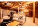 A partially finished basement features exposed ceiling beams and a comfortable entertainment space at 6980 Lamplighter Ln, Winston, GA 30187
