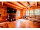Spacious living room with hardwood floors, television, ceiling fan, and natural light at 6980 Lamplighter Ln, Winston, GA 30187