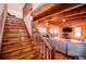 Open-concept living area with exposed wood beams, a staircase, and a connected dining space at 6980 Lamplighter Ln, Winston, GA 30187