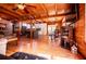 Open living space with wood beam ceilings, a modern kitchen, a dining area, and a cozy living room with comfortable seating at 6980 Lamplighter Ln, Winston, GA 30187